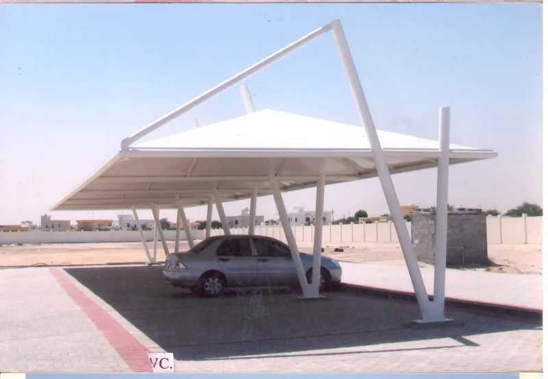 Modern tensile shade canopy over parked vehicles